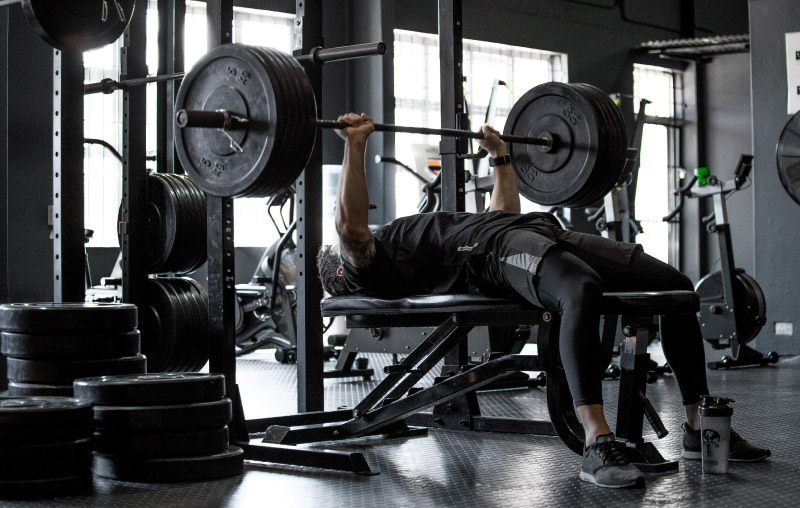 Nutritech athlete performing a bench press