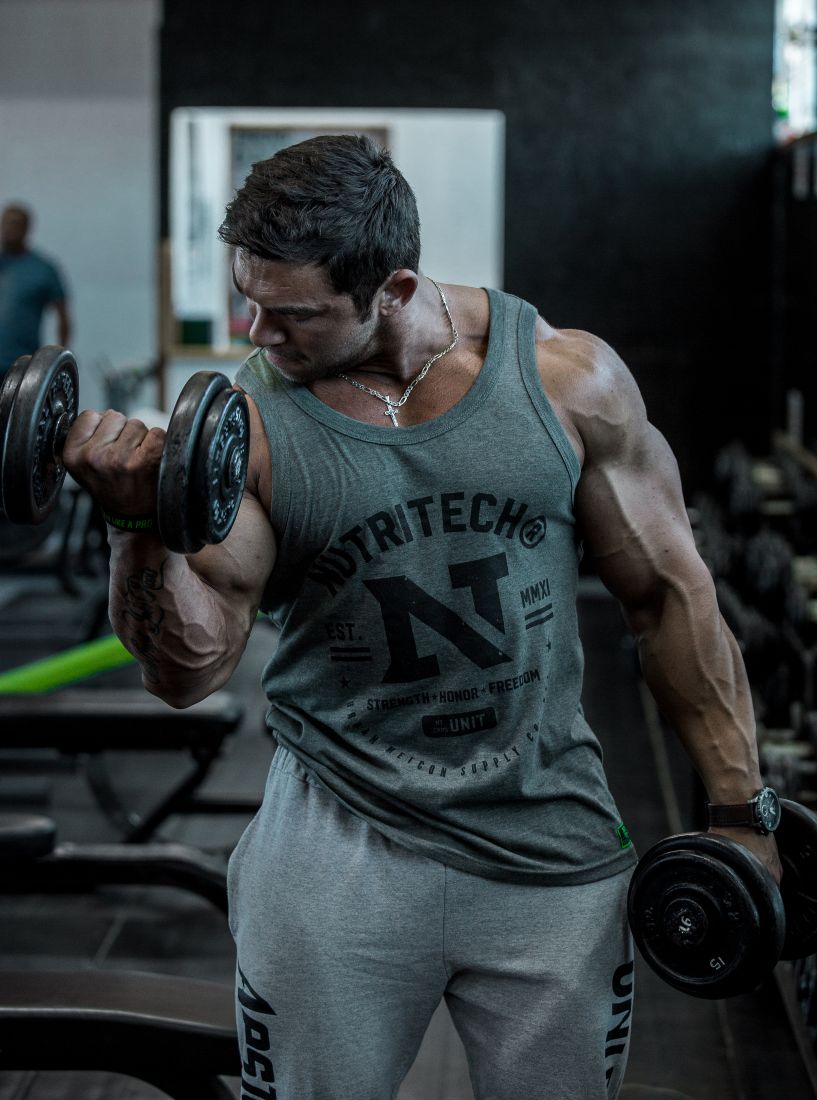 Big bodybuilder doing Dumbbell Bicep Curls